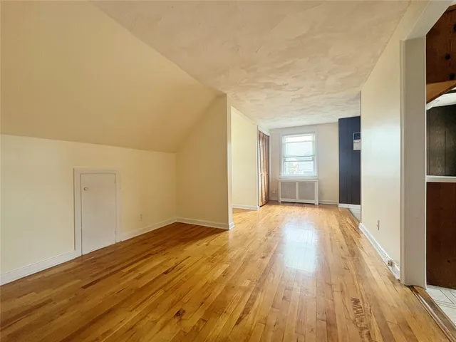 a view of an empty room and wooden floor