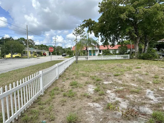 a view of a pathway with a wrought fence