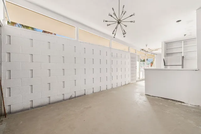 a view of a livingroom with a ceiling fan and window