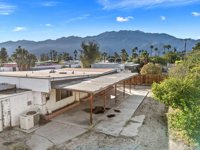 a view of a terrace with a table and chairs