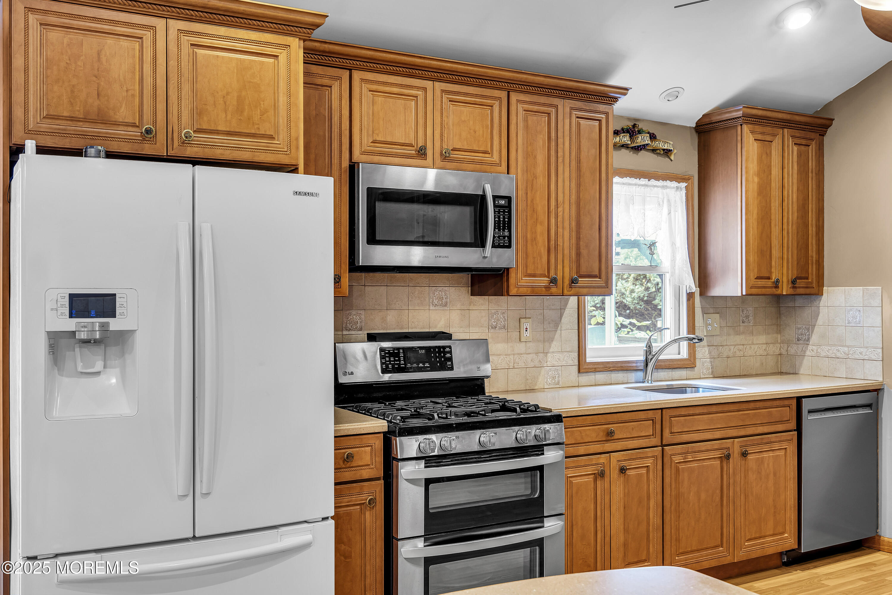 444 Cook Road Jackson, NJ 08527 - Photo 17 of 71 a kitchen with granite countertop cabinets stainless steel appliances and a window