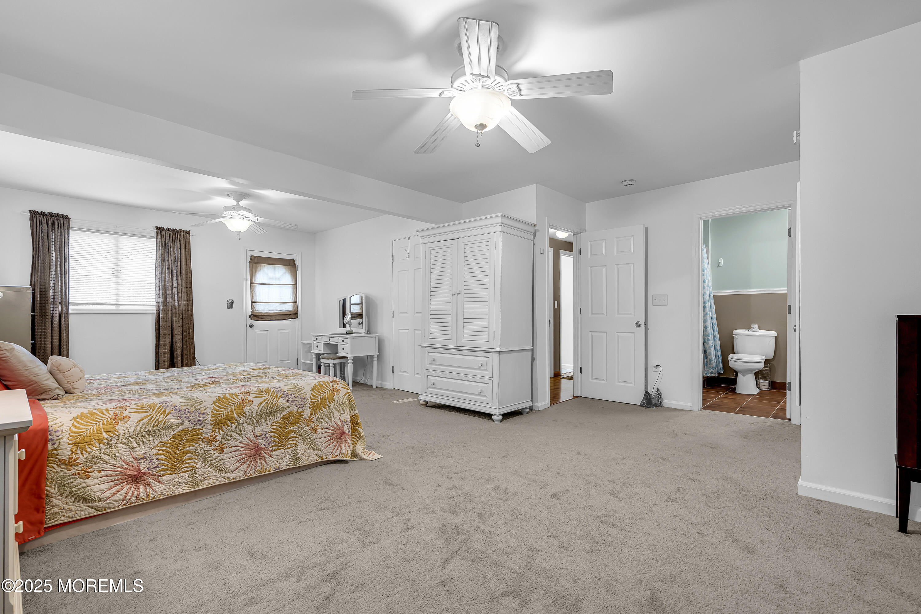 444 Cook Road Jackson, NJ 08527 - Photo 29 of 71 a bed room with a bed and a chandelier