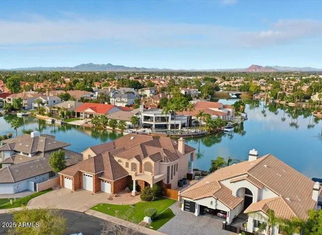 an aerial view of a house with outdoor space and lake view