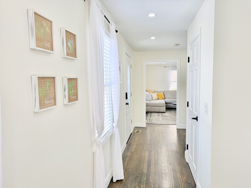 117 A P Newcomb Road Brewster, MA 02631 - Photo 11 of 42 a view of a hallway with wooden floor and furniture