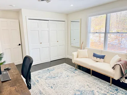 a bedroom with furniture and a window