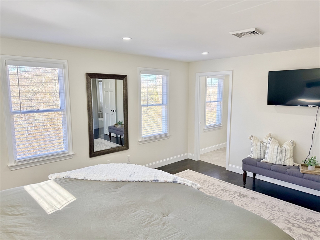 117 A P Newcomb Road Brewster, MA 02631 - Photo 29 of 42 a bedroom with a bed and a flat screen tv