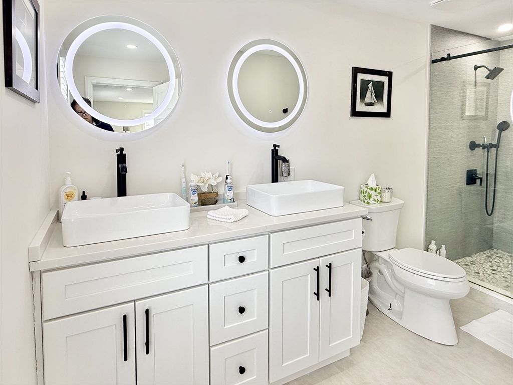 117 A P Newcomb Road Brewster, MA 02631 - Photo 30 of 42 a bathroom with a toilet a sink and a mirror