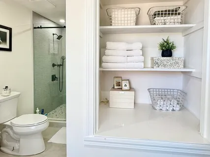 a bathroom with a sink a toilet and a window