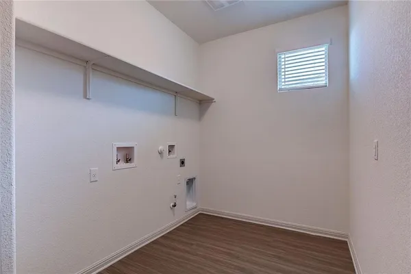 a bathroom with a sink a toilet a mirror and shower