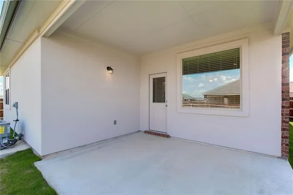 a view of a house with a backyard porch and sitting area