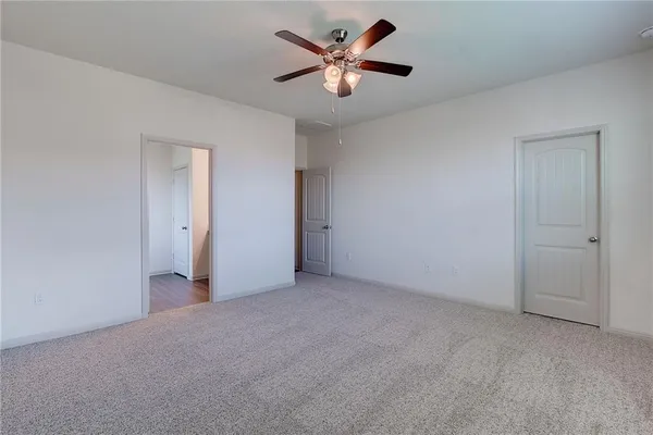 an empty room with kitchen fireplace and wooden floor