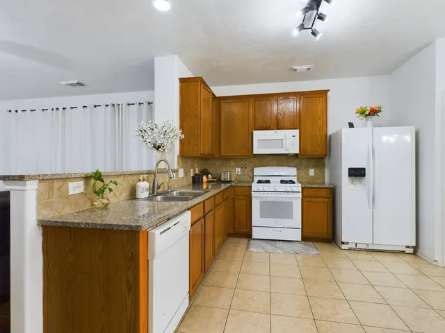 a kitchen with stainless steel appliances granite countertop a sink and cabinets