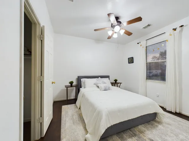 a bedroom with a bed and window