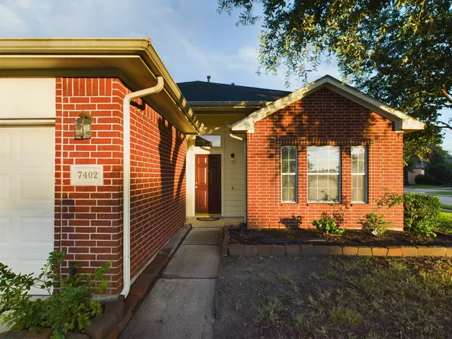 a front view of a house with basket ball court and outdoor seating