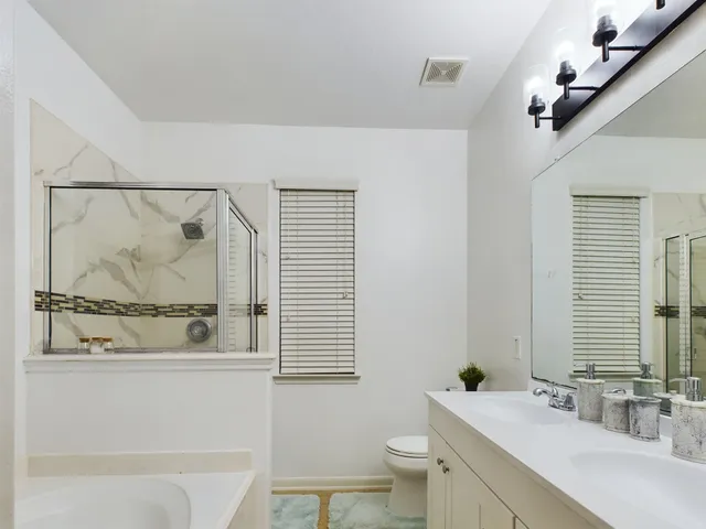 a bathroom with a sink mirror toilet and bathtub