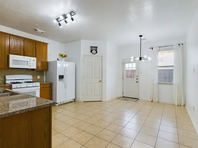 a view of a kitchen with a sink and a refrigerator