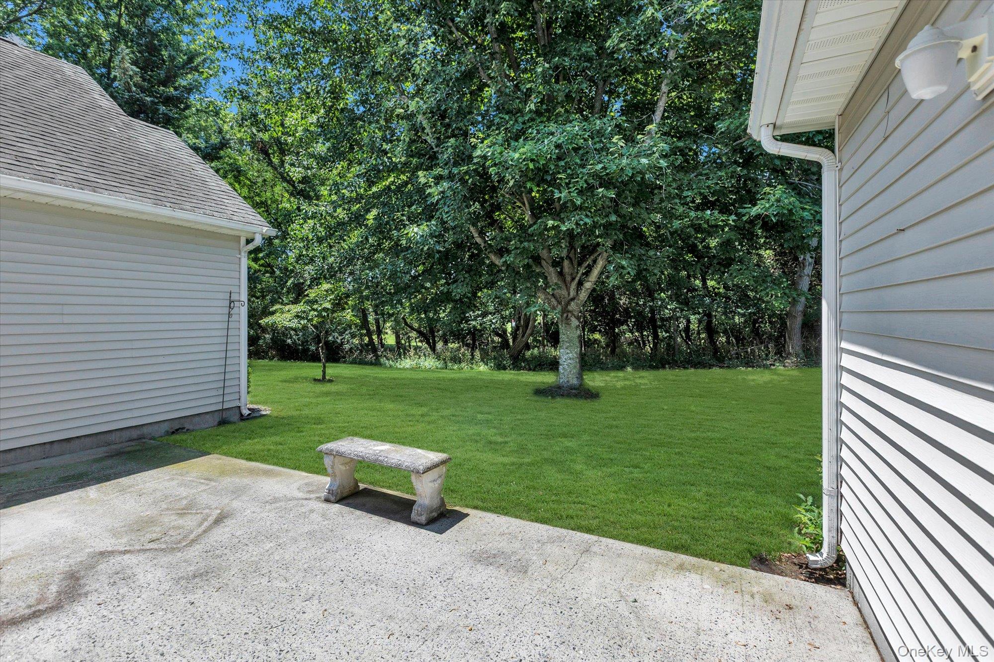 702 Pebble Beach Path Riverhead, NY 11901 - Photo 15 of 17 Back Patio and Yard.