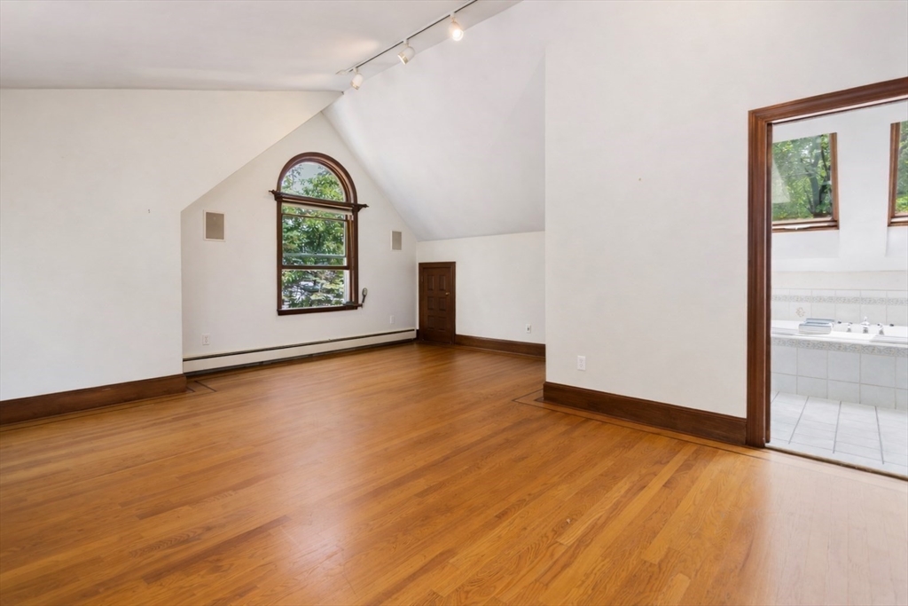 29 Boulevard Road Dedham, MA 02026 - Photo 18 of 34 an empty room with window and wooden floor