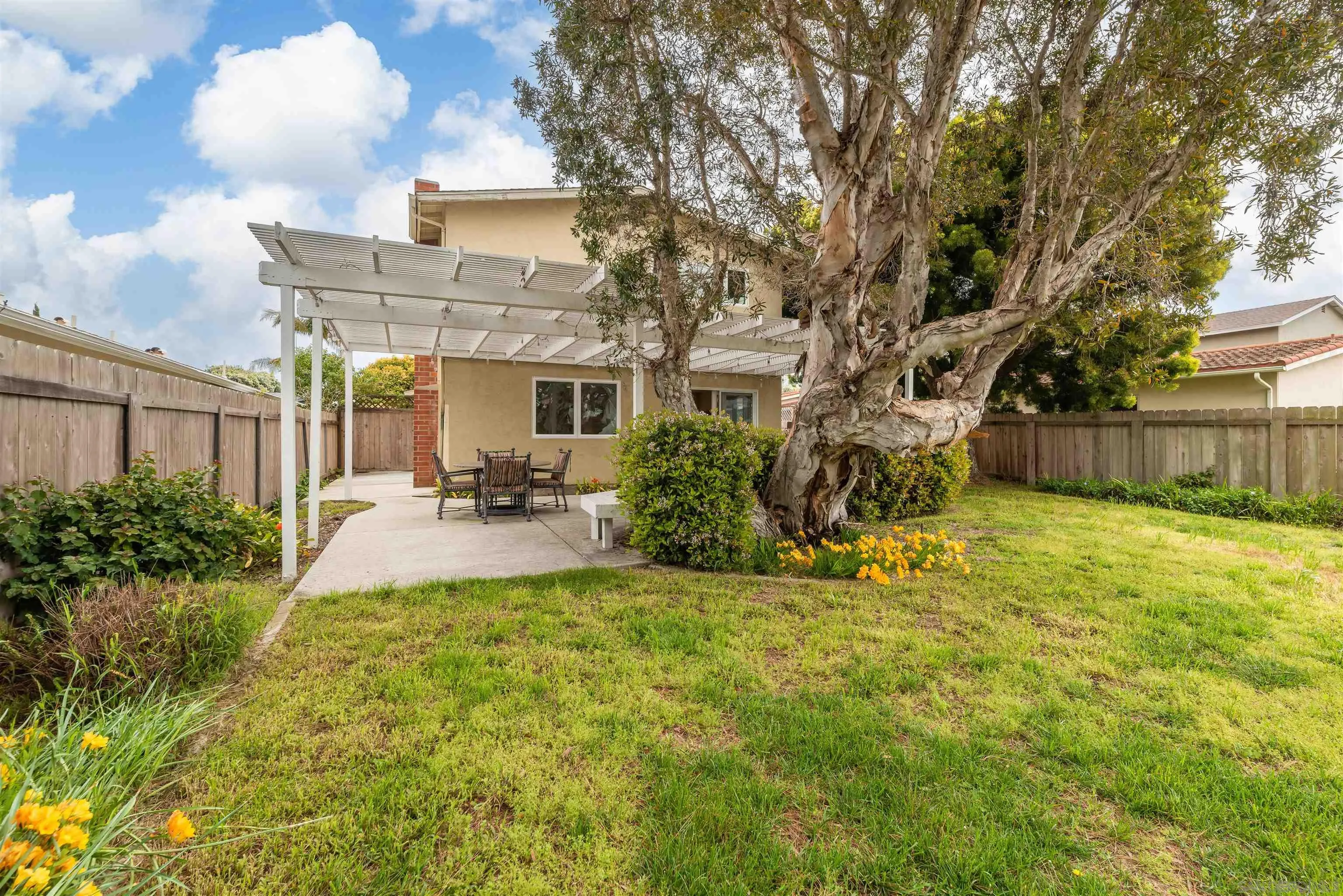 13766 Durango Drive Del Mar, CA 92014 - Photo 21 of 30 a view of a patio with couches chairs and a large tree