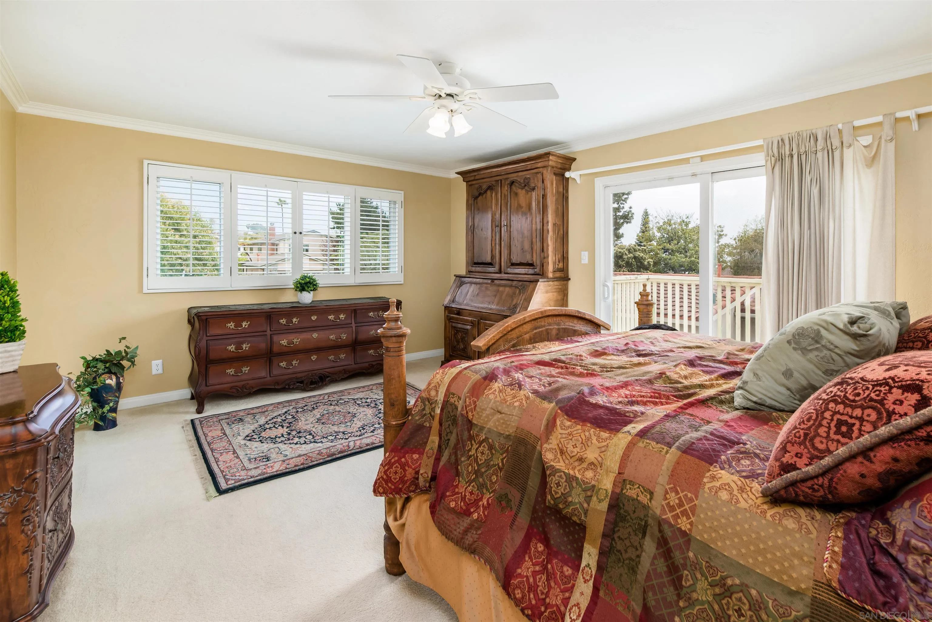 13766 Durango Drive Del Mar, CA 92014 - Photo 25 of 30 a bedroom with a bed a couch and a large window with the outer view