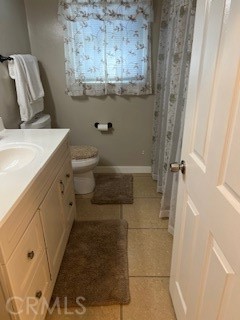 9917 Van Ruiten Street Bellflower, CA 90706 - Photo 13 of 23 a bathroom with a granite countertop sink a toilet and a shower