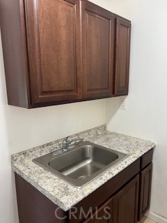 9917 Van Ruiten Street Bellflower, CA 90706 - Photo 21 of 23 a kitchen with granite countertop a sink and cabinets