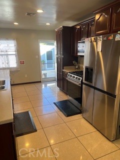 9917 Van Ruiten Street Bellflower, CA 90706 - Photo 6 of 23 a kitchen with granite countertop a refrigerator and a stove