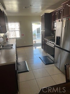 9917 Van Ruiten Street Bellflower, CA 90706 - Photo 7 of 23 a kitchen with granite countertop a refrigerator and a stove