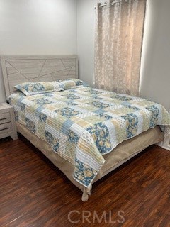 9917 Van Ruiten Street Bellflower, CA 90706 - Photo 10 of 23 a bedroom with a bed and a wooden floor