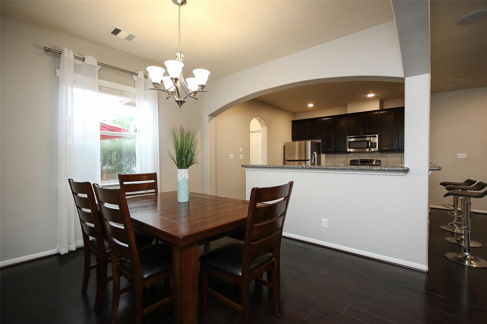 8517 Sunset Loch Drive Spring, TX 77379 - Photo 7 of 22 a view of a dining room with furniture and wooden floor