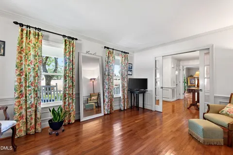 a living room with furniture and a wooden floor