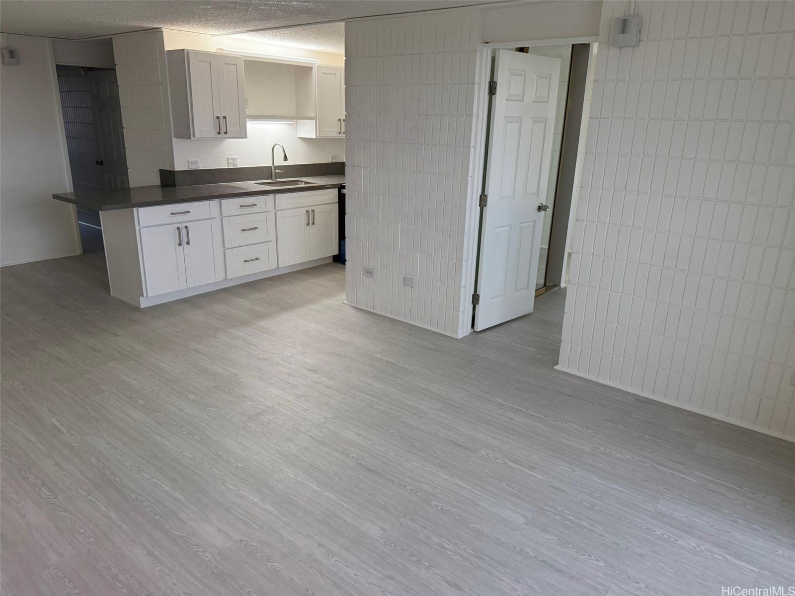 3215 Ala Ilima Street, Unit A1202 Honolulu, HI 96818 - Photo 11 of 20 a large bathroom with a granite countertop sink and a mirror