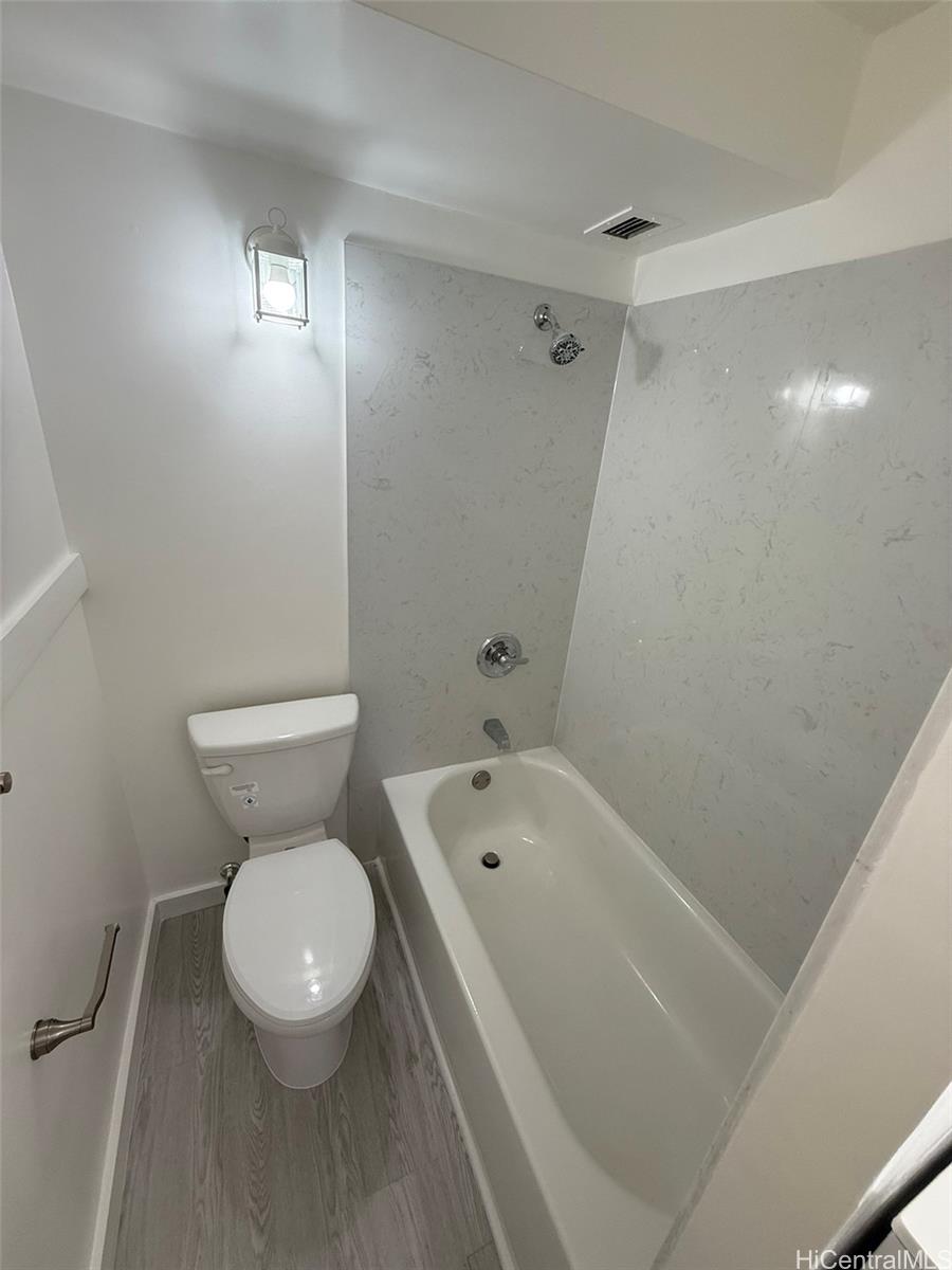3215 Ala Ilima Street, Unit A1202 Honolulu, HI 96818 - Photo 15 of 20 a white toilet sitting next to a bath tub