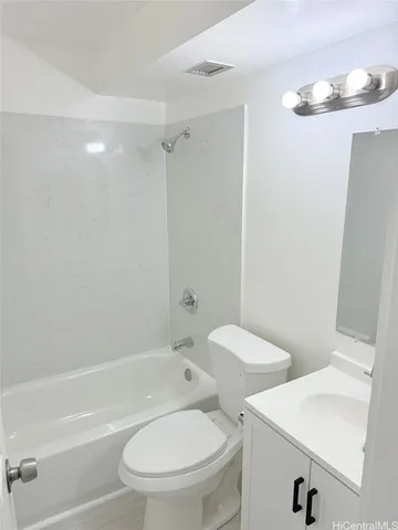 a bathroom with a toilet and a bath tub