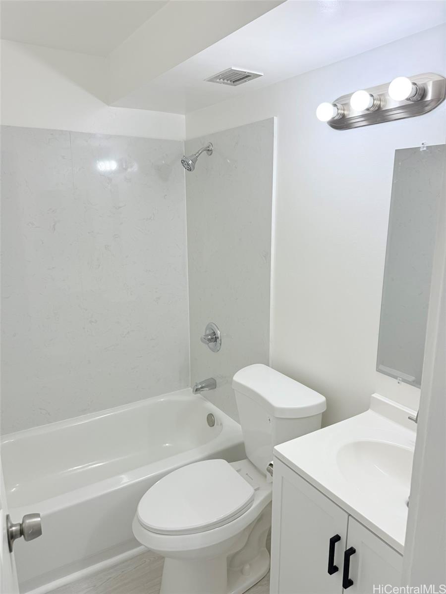 3215 Ala Ilima Street, Unit A1202 Honolulu, HI 96818 - Photo 3 of 20 a white toilet sitting next to a bath tub