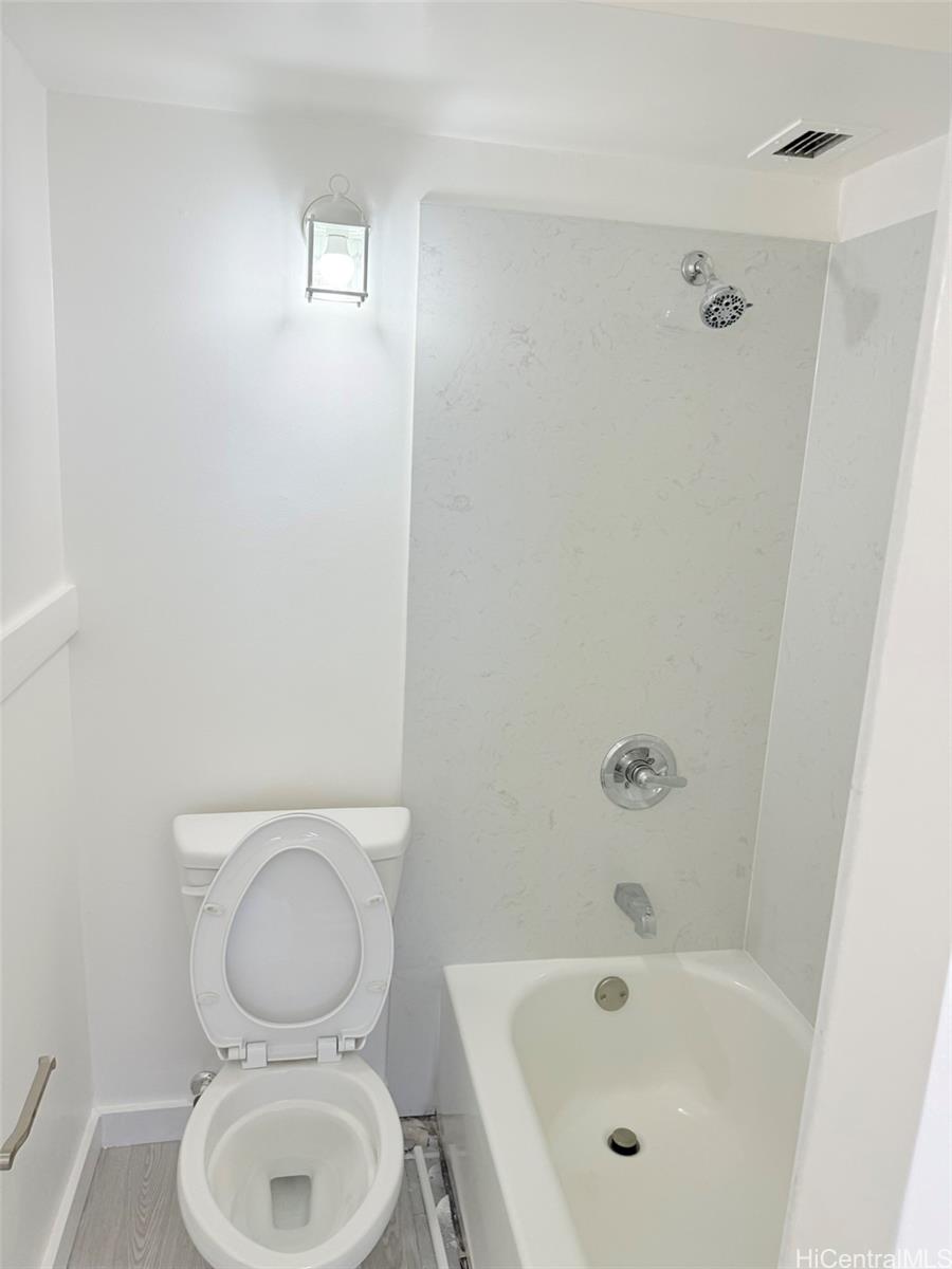 3215 Ala Ilima Street, Unit A1202 Honolulu, HI 96818 - Photo 9 of 20 a white toilet sitting next to a bath tub