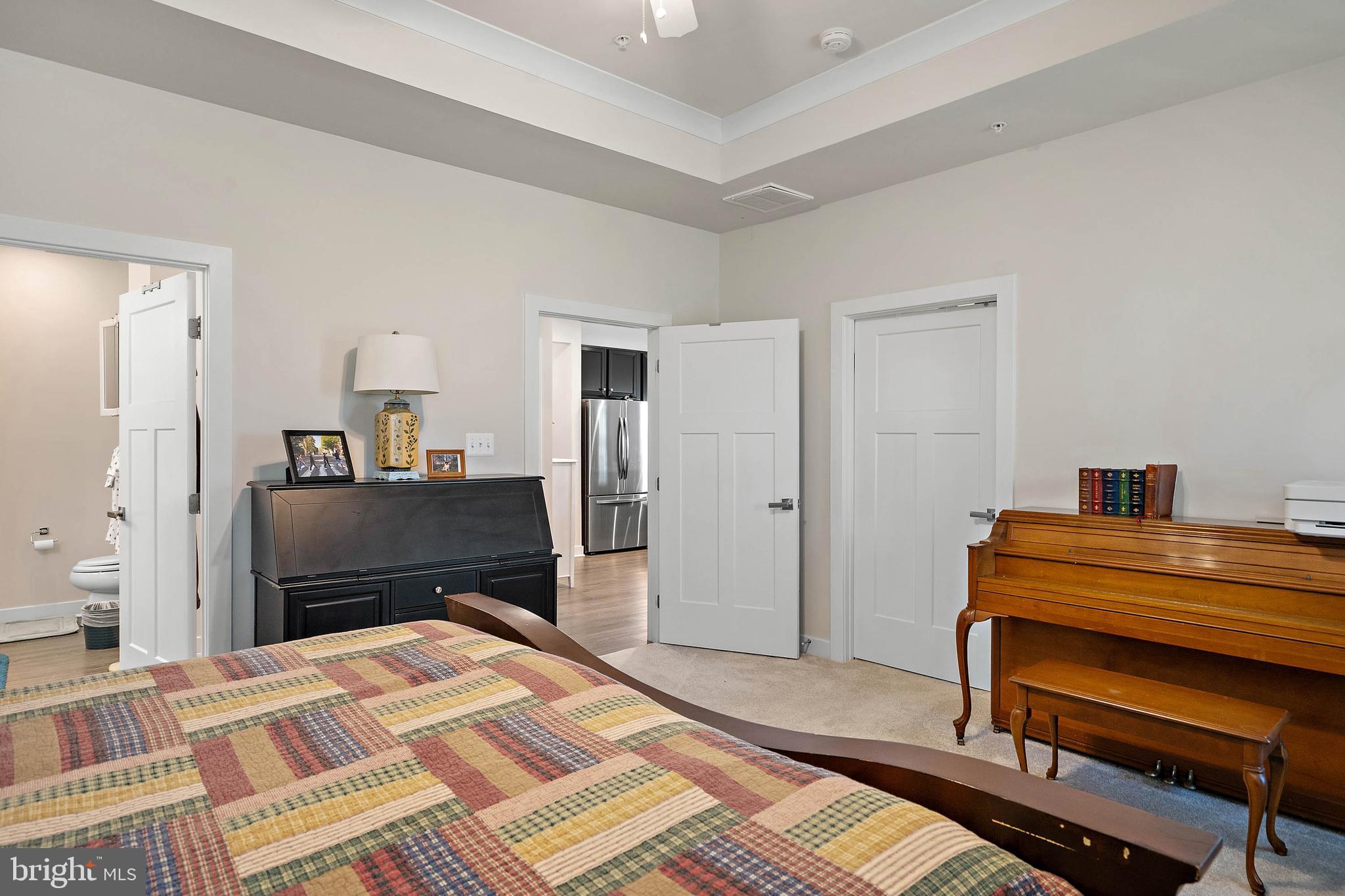 12159 Snug Harbor Road Berlin, MD 21811 - Photo 20 of 72 a bedroom with a bed and a chandelier