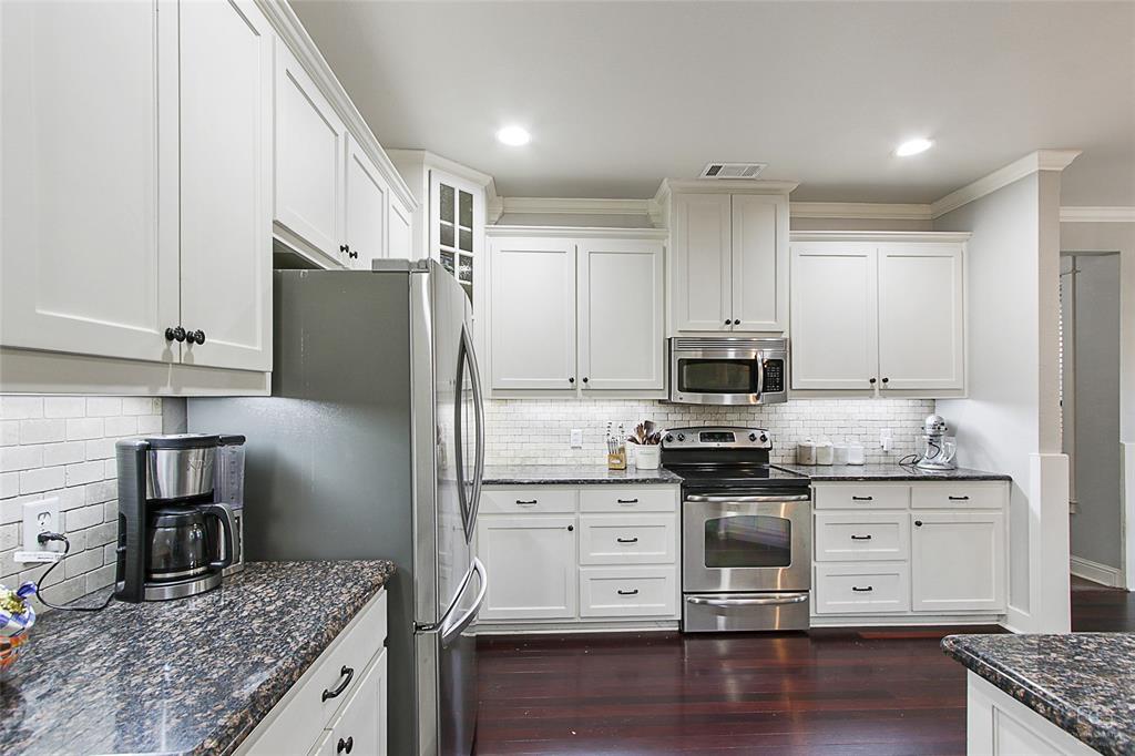 263 West Jefferson Street Van Alstyne, TX 75495 - Photo 12 of 32 a kitchen with stainless steel appliances granite countertop a stove and a refrigerator