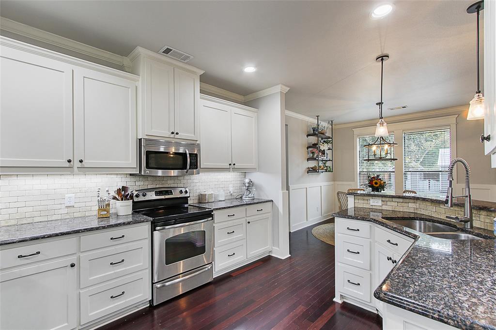 263 West Jefferson Street Van Alstyne, TX 75495 - Photo 13 of 32 a kitchen with stainless steel appliances white cabinets a sink a stove a refrigerator and microwave