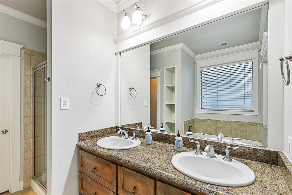 263 West Jefferson Street Van Alstyne, TX 75495 - Photo 23 of 32 a bathroom with a granite countertop sink a mirror and a shower