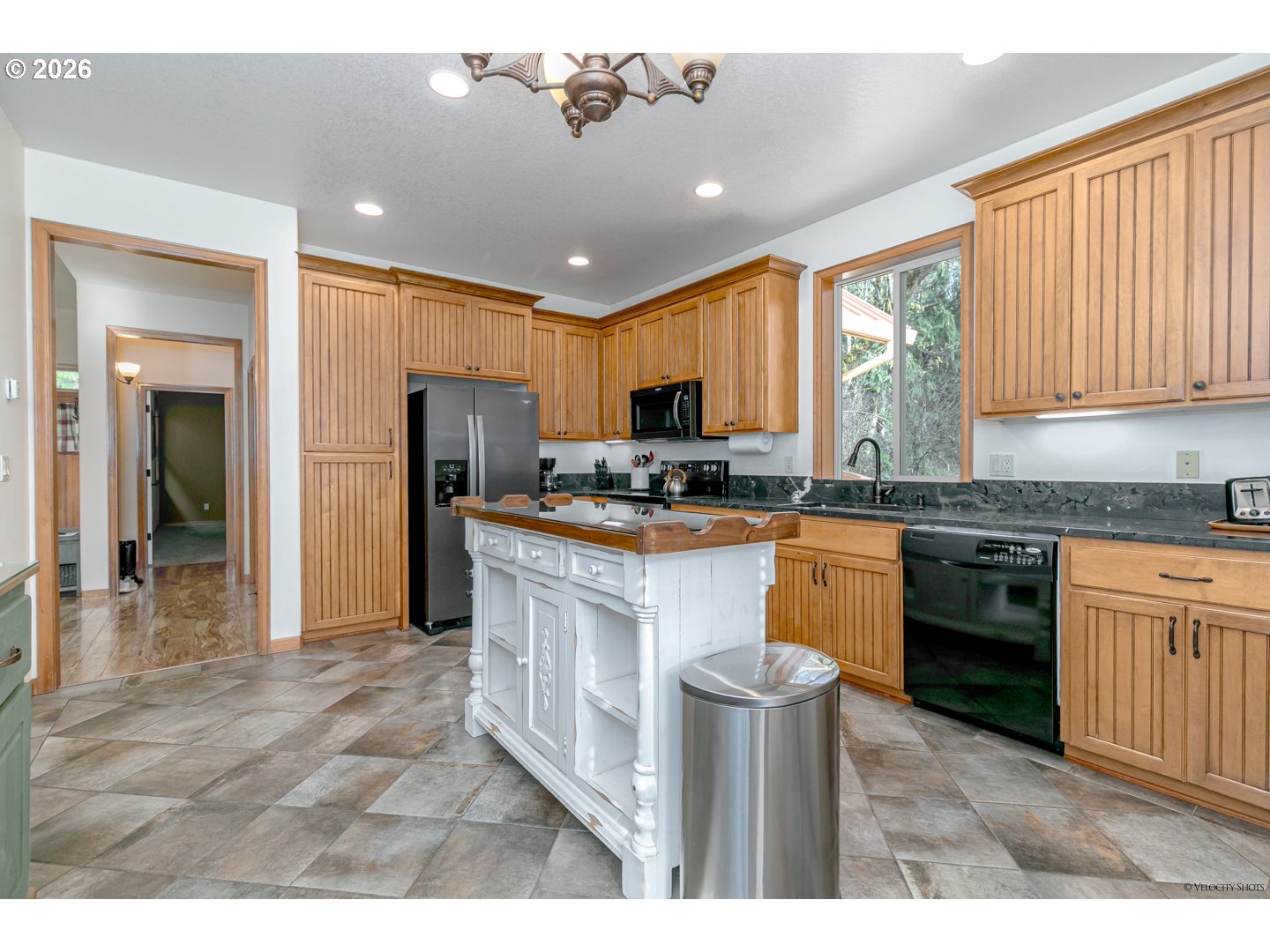 64636 Mc Intyre Road Rhododendron, OR 97049 - Photo 16 of 48 a kitchen with kitchen island granite countertop a stove top oven a sink a counter top space and cabinets
