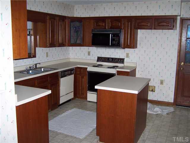 2413 Scouting Trail Raleigh, NC 27615 - Photo 5 of 14 a kitchen with a sink stove top oven and cabinets