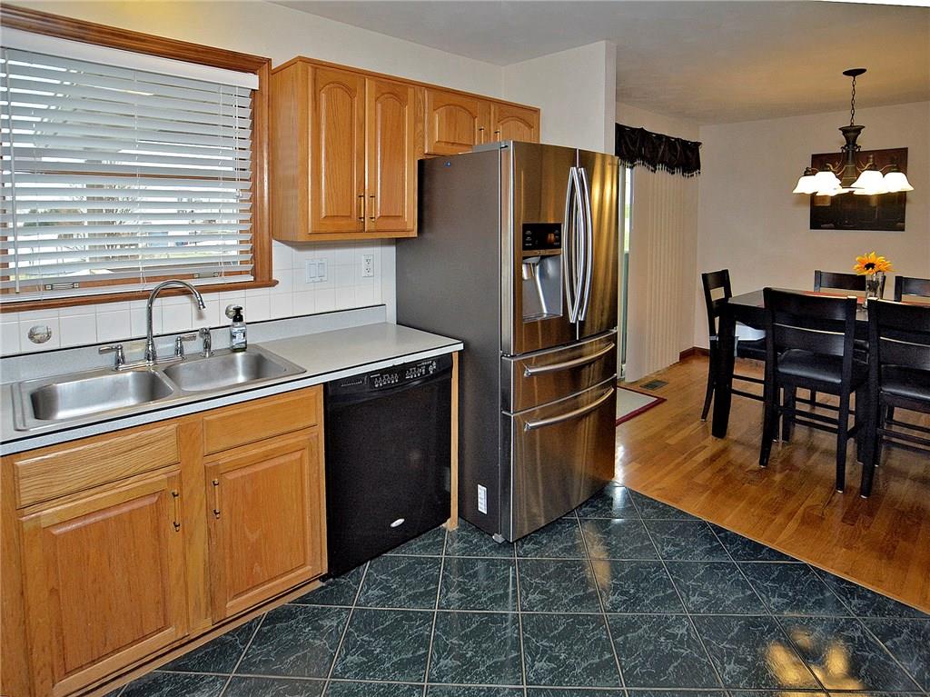 77 Rustic Ridge Drive Pittsburgh, PA 15239 - Photo 3 of 25 Double bowl sink and dishwasher and refrigerator included. Kitchen opens to dining room.