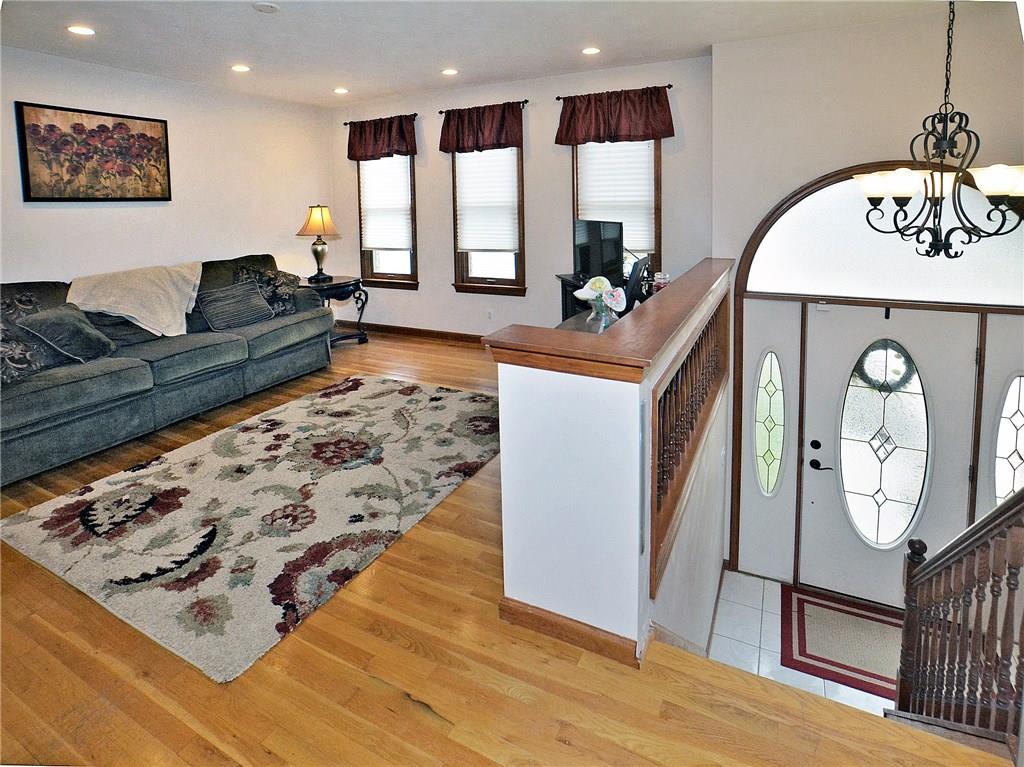 77 Rustic Ridge Drive Pittsburgh, PA 15239 - Photo 8 of 25 Living room with hardwood floors and recessed lighting.