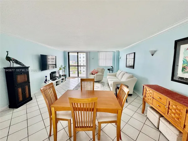 a living room with furniture a flat screen tv and a window