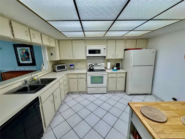 a kitchen with a sink appliances and cabinets