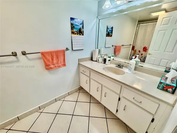 a spacious bathroom with a sink mirror and vanity