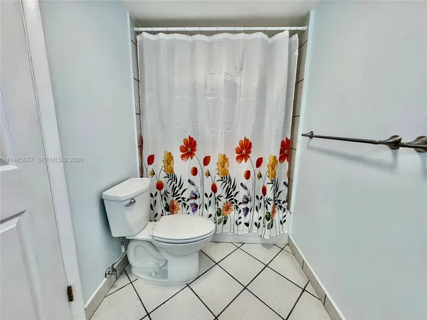 a view of a room that has a table and a chair