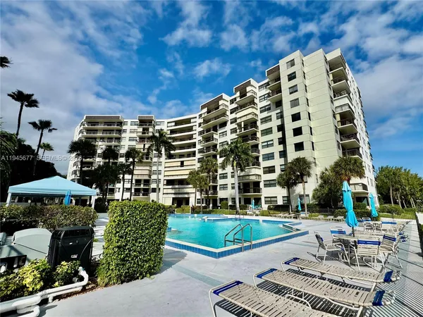 a view of a patio with a table and chairs and potted plants