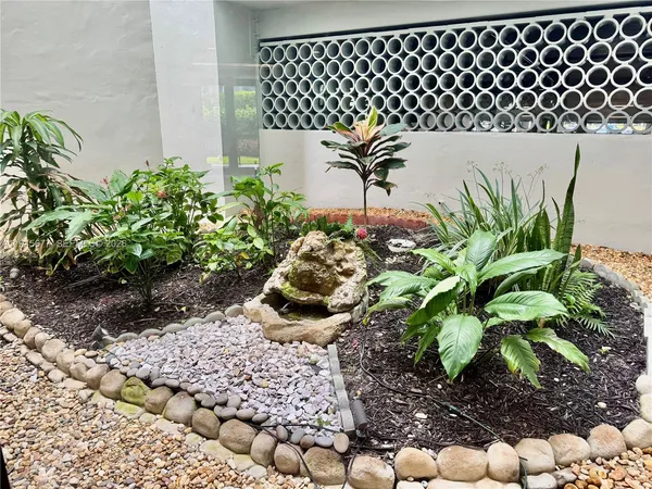 a view of a patio with a table and chairs